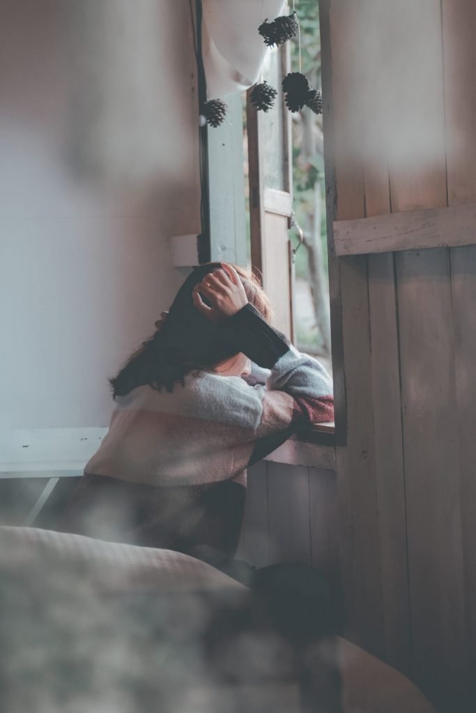 photo of a person leaning on wooden window 1510149 scaled 1